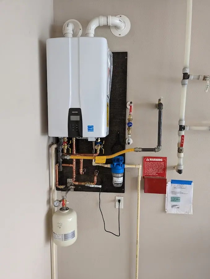 Professional plumber installing copper piping in a Gloucester Courthouse home